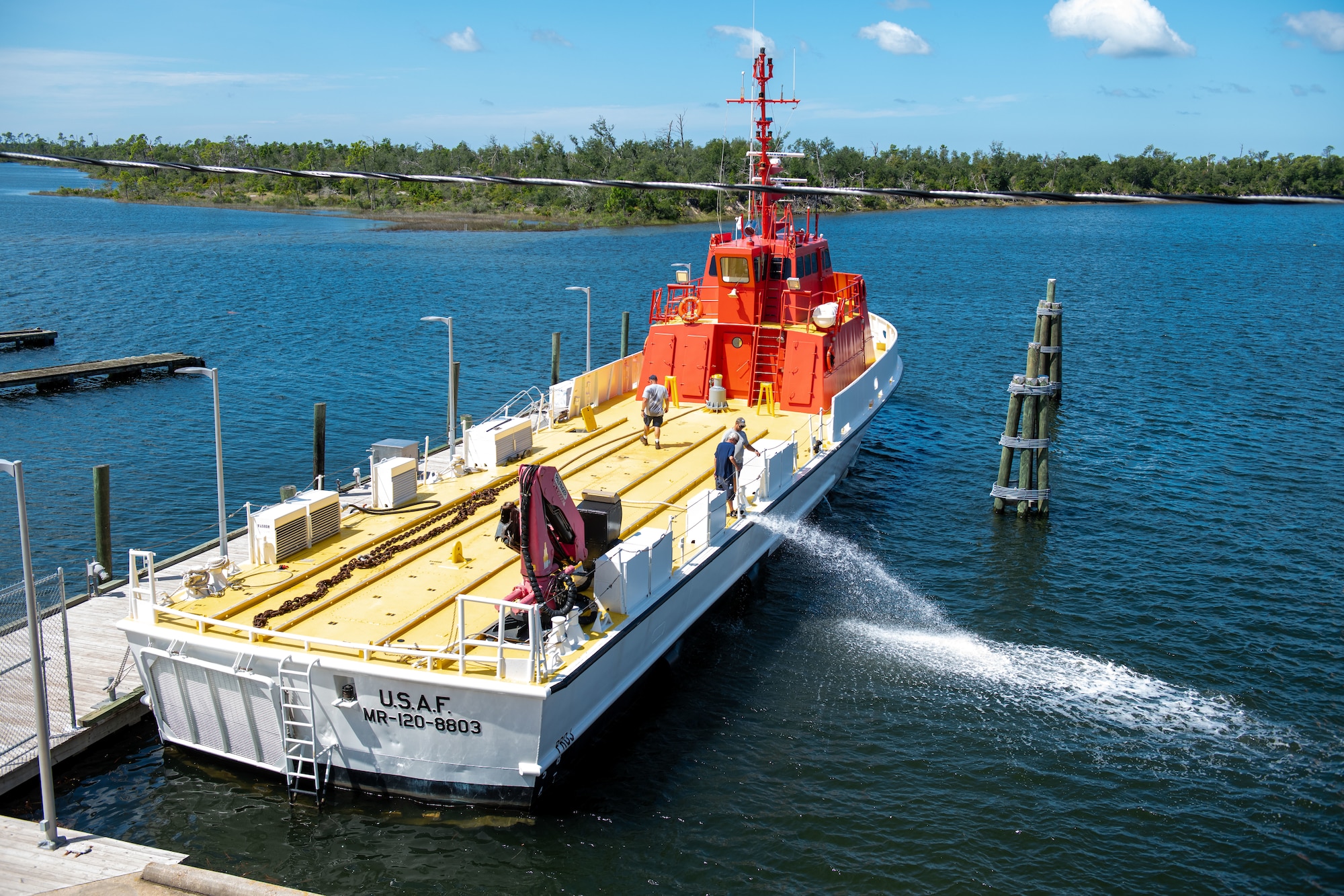 Boat crew washes off large vessel.