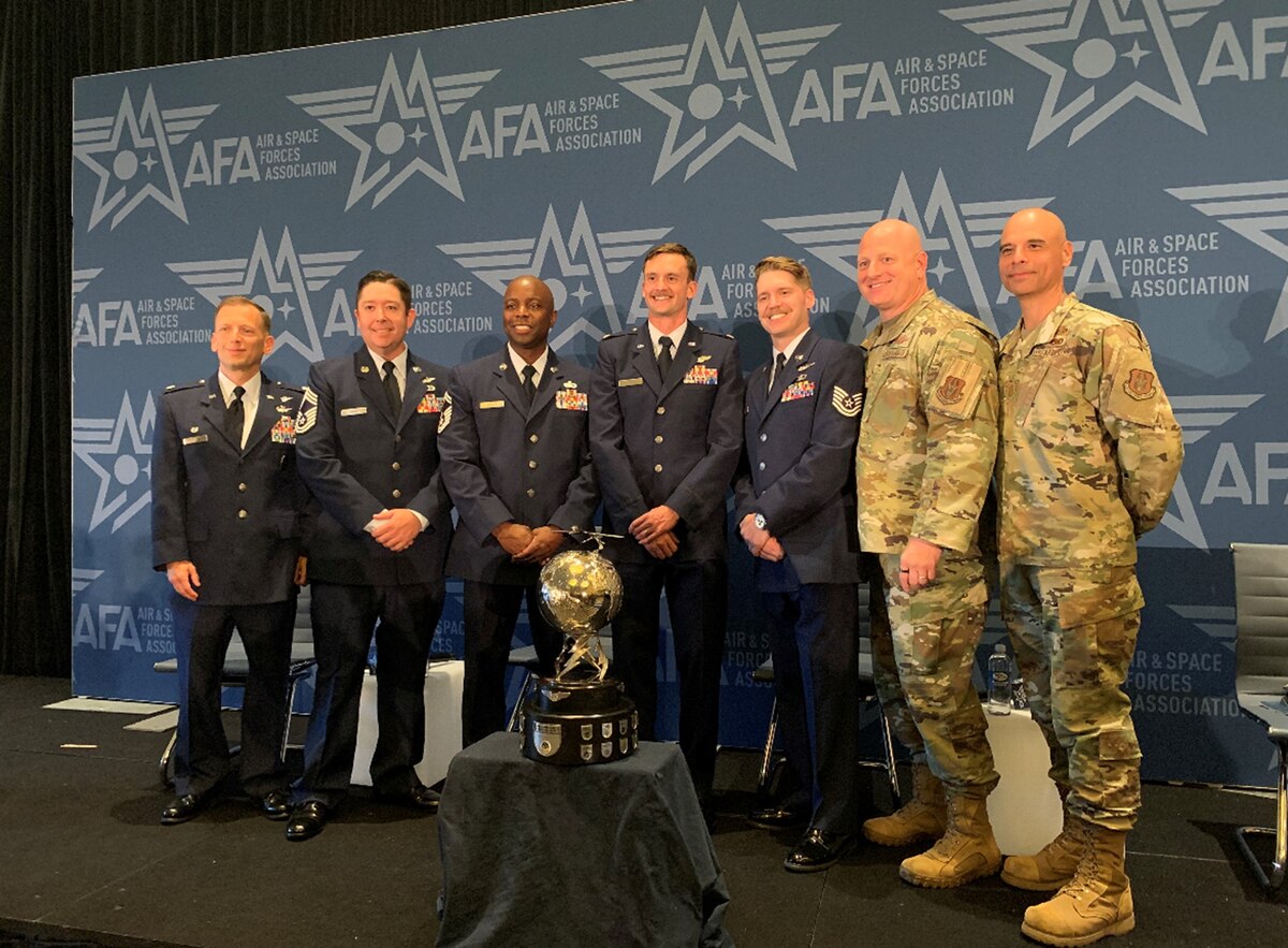 Members of the 2nd Special Operations Squadron take time for a photo with Col. Jason Grandy, 919th Special Operations Wing commander (second from the right) and Chief Master Sgt. Manuel Zubia, 919th SOW command chief at the Air Force Symposium in Washington, D.C. Sept. 11, 2023. The squadron earned the prestigious 2023 General Atomics Aeronautical Systems Trophy as the most outstanding MQ-9 Remotely Piloted Aircraft squadron in the Air Force. (Courtesy Photo)