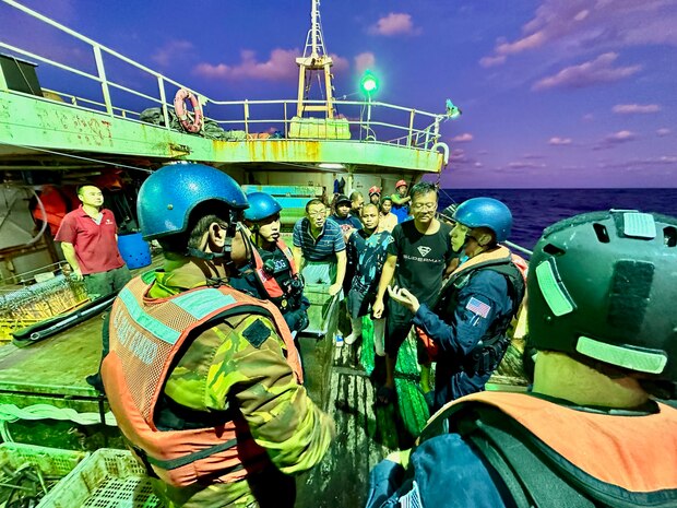 Members of a USCGC Myrtle Hazard (WPC 1139) boarding team and an officer from the Papua New Guinea Defence Force talk to the crew on a fisheries boarding on a People’s Republic of China-flagged fishing vessel during a combined patrol on Sept. 1, 2023, in the Coral Sea off Papua New Guinea. The U.S. Coast Guard was in Papua New Guinea at the invitation of the PNG government to join their lead in maritime operations to combat illegal fishing and safeguard marine resources following the recent signing and ratification of a bilateral maritime law enforcement agreement between the United States and Papua New Guinea. (U.S. Coast Guard photo by Chief Warrant Officer Sara Muir)
