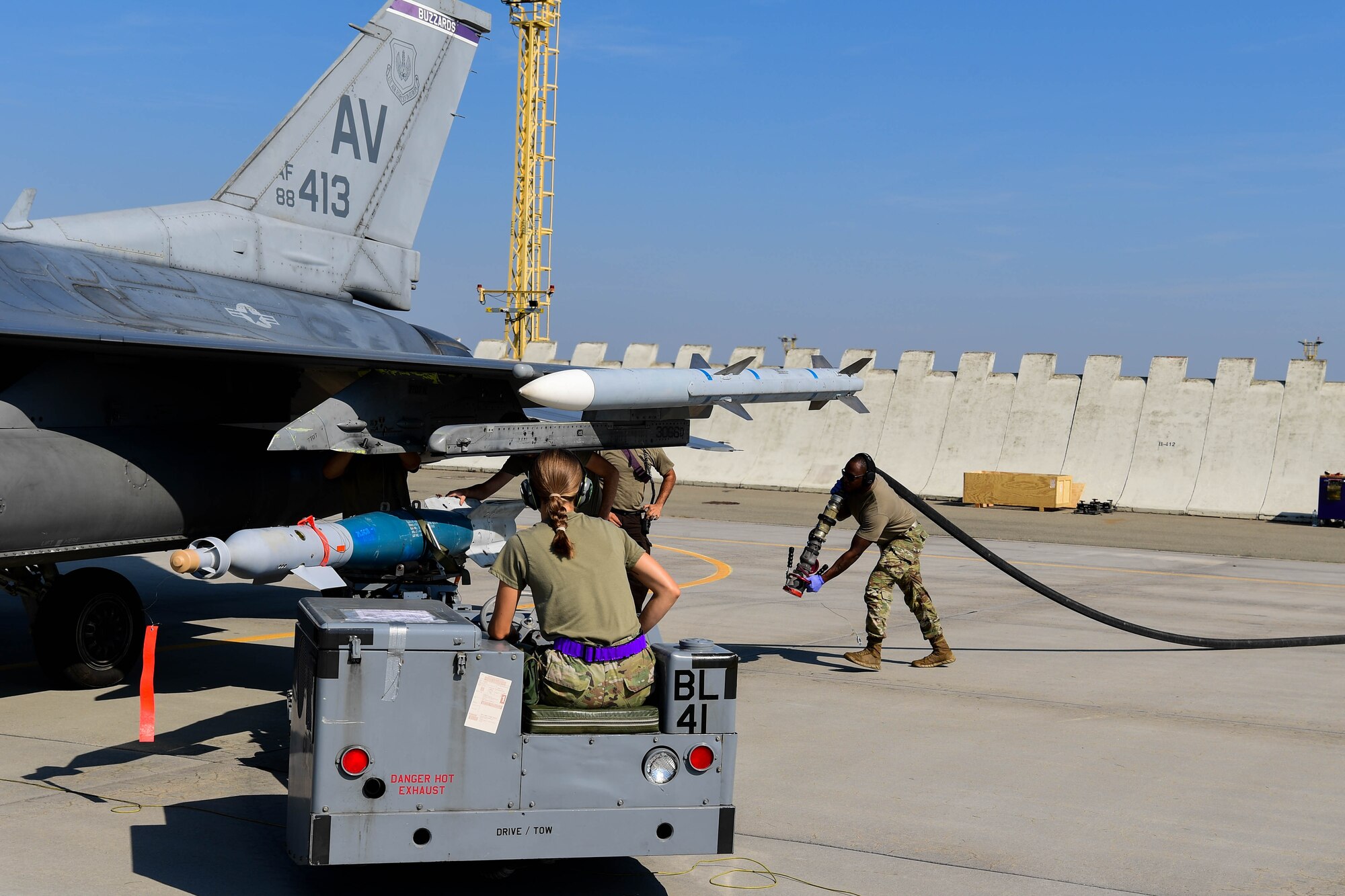 U.S. Air Force Airmen with the 31st Munitions Squadron loads an Inert GBU-12 on an F-16 Fighting Falcon during exercise Ample Strike.