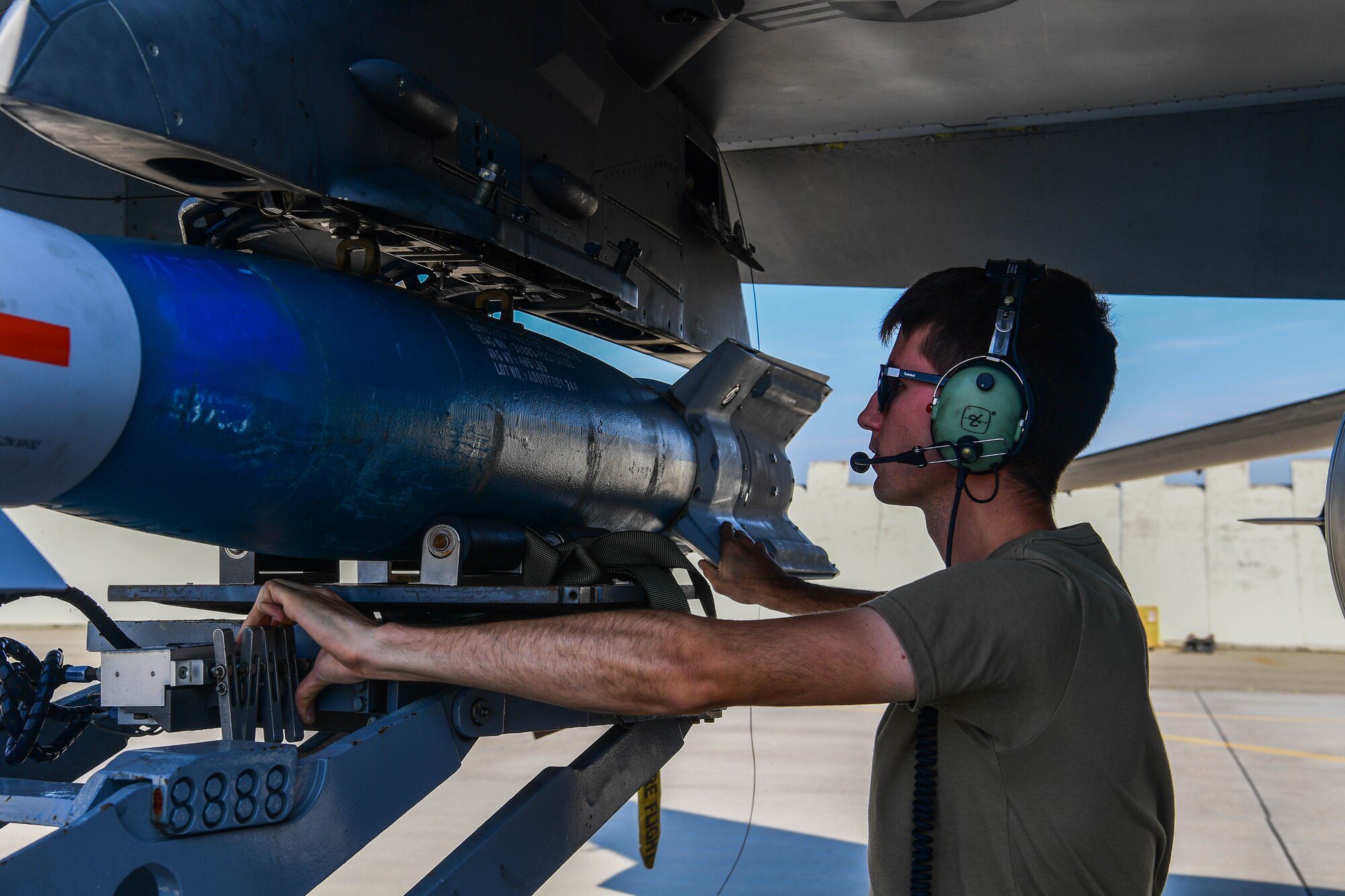 U.S. Air Force Airman with the 31st Munitions Squadron loads an Inert GBU-12 on an F-16 Fighting Falcon during exercise Ample Strike.
