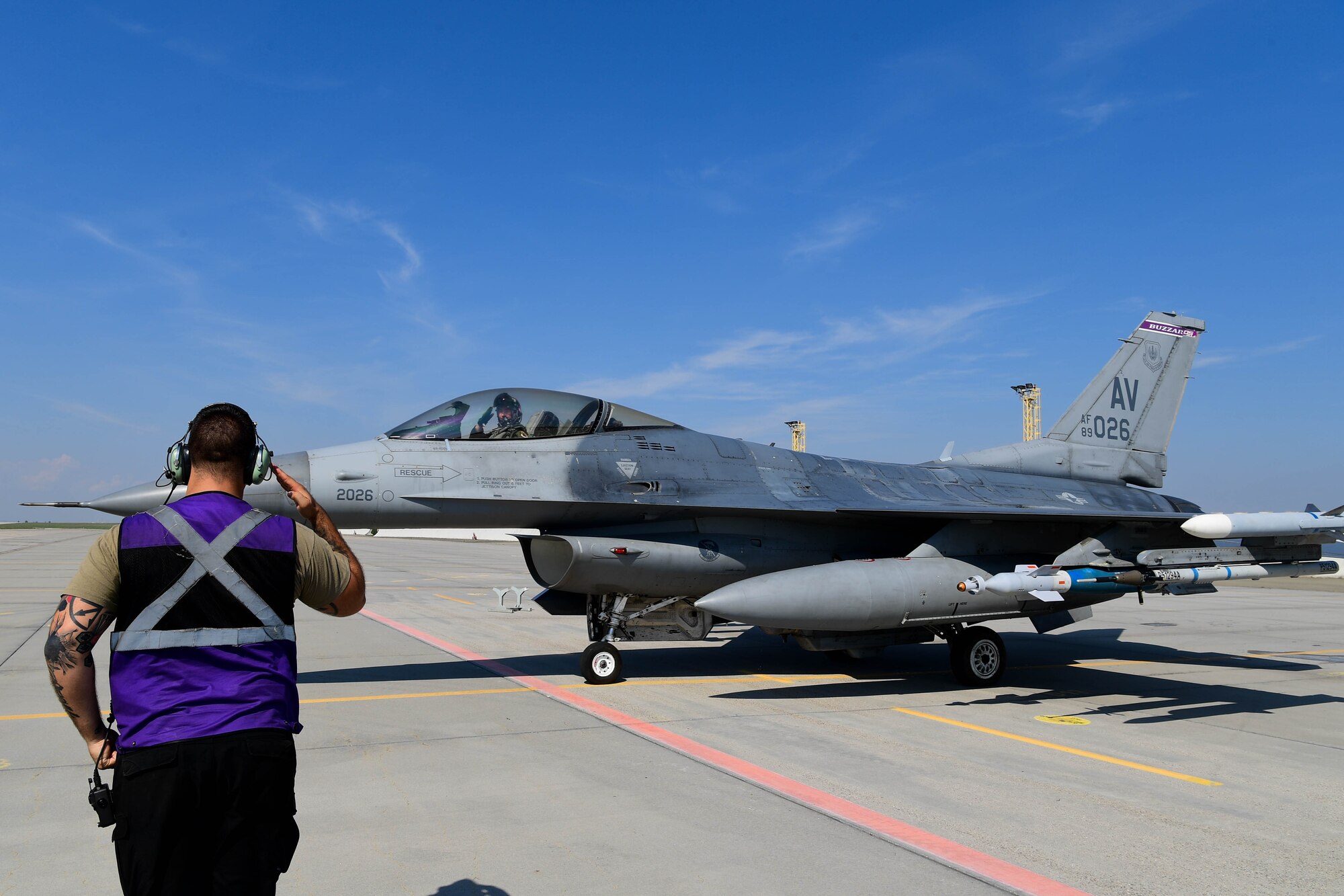 U.S. Air Force Airman from the 510th Fighter Generation Squadron marshals a jet during exercise Ample Strike.