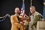 Col. Daniel Kent, commander of the U.S Army Corps of Engineers, Europe District presents the key to the school to the current principal Michael Defrancesco during the ribbon-cutting for the new Grafenwoehr Elementary School in Grafenwoehr, Germany Sept. 12, 2023. Officials from the Department of Defense Education Activity, U.S. Army Corps of Engineers, U.S. Army Garrison Bavaria, 7th Army Training Command and more participated in the ribbon cutting ceremony for the new school. (U.S. Army photo by Richard Puckett)