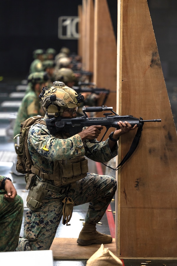U.S. Marine Corps Maj. Corey Lockhart, the expeditionary advanced base force commander for Marine Rotational Force-Southeast Asia (MRF-SEA), I Marine Expeditionary Force, sights in with a Singaporean Assault Rifle 21 service rifle at a 100-meter live-fire range during Exercise Valiant Mark 2022 at the Multi-Mission Range Complex on Pasir Laba Camp, Singapore, Dec. 2, 2022. Valiant Mark is an annual, bilateral training exercise designed to enhance interoperability, build mutual defense capabilities, and strengthen military-to-military relationships between the U.S. Marine Corps and Singapore Armed Forces. MRF-SEA is an operational model developed by Marine Corps Forces Pacific that postures scalable I Marine Expeditionary Forces west of the International Date Line, conducts a series of planned subject matter experts exchanges, and advances security objectives shared with our Allies and Partners. (U.S. Marine Corps photo by Sgt. Ryan H. Pulliam)