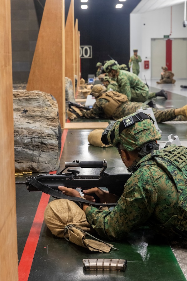 Singapore Army soldiers with 7th Singapore Infantry Brigade and U.S. Marines with Marine Rotational Force-Southeast Asia (MRF-SEA), I Marine Expeditionary Force, participate in a shooting competition using Singaporean Assault Rifle 21 service rifles on a 100-meter range during Exercise Valiant Mark 2022 at the Multi-Mission Range Complex on Pasir Laba Camp, Singapore, Dec. 2, 2022. Valiant Mark is an annual, bilateral training exercise designed to enhance interoperability, build mutual defense capabilities, and strengthen military-to-military relationships between the U.S. Marine Corps and Singapore Armed Forces. MRF-SEA is an operational model developed by Marine Corps Forces Pacific that postures scalable I Marine Expeditionary Forces west of the International Date Line, conducts a series of planned subject matter experts exchanges, and advances security objectives shared with our Allies and Partners. (U.S. Marine Corps photo by Sgt. Ryan H. Pulliam)