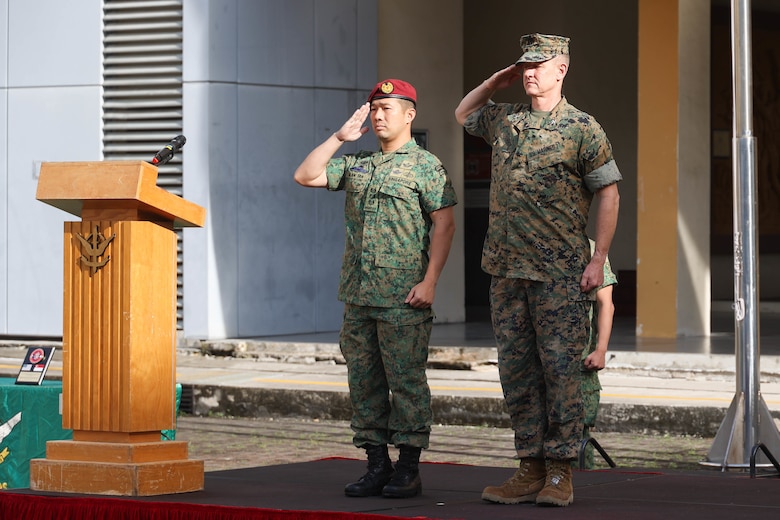 Singapore Guard Col. Tan Yukun Alan, left, commander of 7th Singapore Infantry Brigade, and U.S. Marine Corps Col. Thomas M. Siverts, commanding officer of Marine Rotational Force Southeast Asia (MRF-SEA), I Marine Expeditionary Force, salute during the closing ceremony for Exercise Valiant Mark 2022 on Bedok Camp II, Singapore, Dec. 6, 2022. Valiant Mark is an annual, bilateral training exercise designed to enhance interoperability, build mutual defense capabilities, and strengthen military-to-military relationships between the U.S. Marine Corps and Singapore Armed Forces. MRF-SEA is an operational model developed by Marine Corps Forces Pacific that postures scalable I Marine Expeditionary Forces west of the International Date Line, conducts a series of planned subject matter expert exchanges, and advances security objectives shared with our Allies and Partners. (U.S. Marine Corps photo by Sgt. Jailine L. AliceaSantiago)