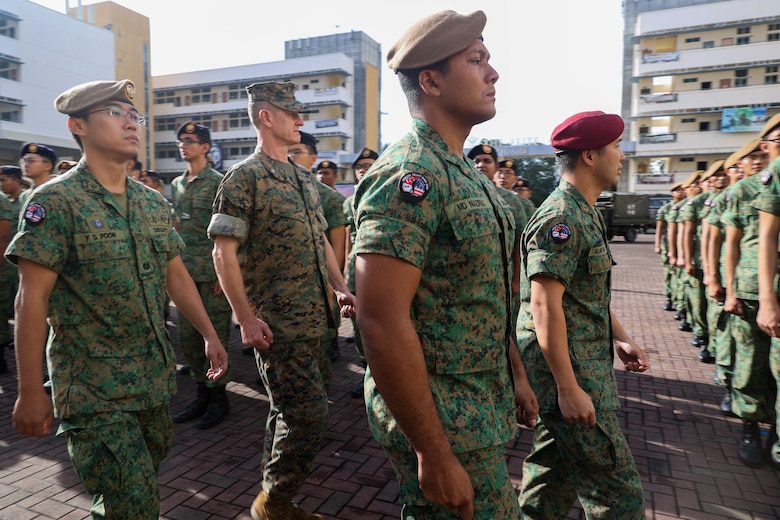 Singapore Guard Col. Tan Yukun Alan, left, commander of 7th Singapore Infantry Brigade, and U.S. Marine Corps Col. Thomas M. Siverts, commanding officer of Marine Rotational Force Southeast Asia (MRF-SEA), I Marine Expeditionary Force, conduct a parade inspection during the closing ceremony for Exercise Valiant Mark 2022 on Bedok Camp II, Singapore, Dec. 6, 2022. Valiant Mark is an annual, bilateral training exercise designed to enhance interoperability, build mutual defense capabilities, and strengthen military-to-military relationships between the U.S. Marine Corps and Singapore Armed Forces. MRF-SEA is an operational model developed by Marine Corps Forces Pacific that postures scalable I Marine Expeditionary Forces west of the International Date Line, conducts a series of planned subject matter expert exchanges, and advances security objectives shared with our Allies and Partners. (U.S. Marine Corps photo by Sgt. Jailine L. AliceaSantiago)