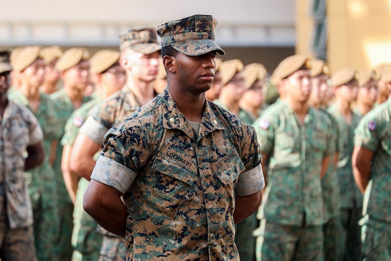 U.S. Marine Corps Maj. Cory Lockhart, expeditionary advanced base force officer-in-charge, with Marine Rotational Force-Southeast Asia (MRF-SEA), I Marine Expeditionary Force, stands in formation during the closing ceremony for Exercise Valiant Mark 2022 on Bedok Camp II, Singapore, Dec. 6, 2022. Valiant Mark is an annual, bilateral training exercise designed to enhance interoperability, build mutual defense capabilities, and strengthen military-to-military relationships between the U.S. Marine Corps and Singapore Armed Forces. MRF-SEA is an operational model developed by Marine Corps Forces Pacific that postures scalable I Marine Expeditionary Forces west of the International Date Line, conducts a series of planned subject matter expert exchanges, and advances security objectives shared with our Allies and Partners. (U.S. Marine Corps photo by Sgt. Jailine L. AliceaSantiago)