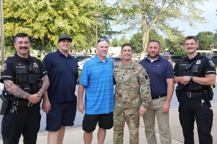U.S. Army Lt. Col. Mark Martella, firefighter Keith Still, Officers Dylan Canada and Michael Tappen are presented with the Manheim Township Police Department’s Citation for Excellence for the life saving measures taken on June 1, 2023 providing CPR to an unconscious man in Lancaster, pa Aug. 28, 2023. (U.S. Army National Guard photo by 2nd Lt. Kate Kramer)