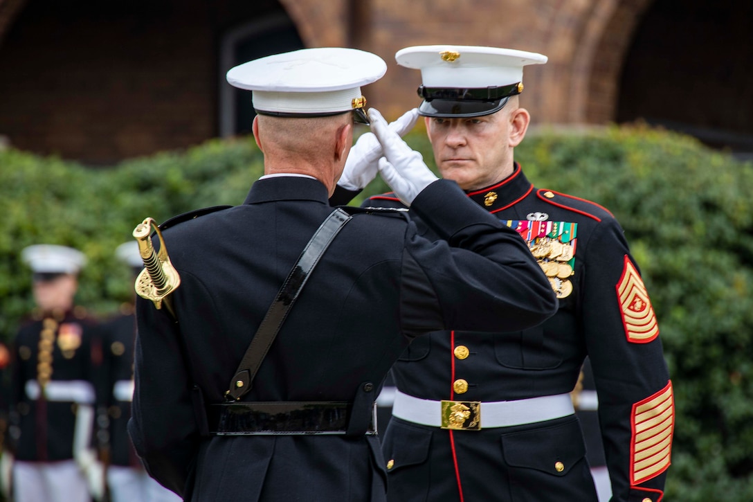 Sergeant Maj. Troy E. Black, the 19th Sergeant Major of the Marine Corps, transfers the sword of office to Gen. Eric M. Smith, Assistant Commandant of the Marine Corps, during the Sergeant Major of the Marine Corps relief and appointment ceremony at Marine Barracks Washington, D.C., Aug. 10, 2023. Sgt. Maj. Carlos A. Ruiz assumed the duties and responsibilities of Sergeant Major of the Marine Corps from Sgt. Maj. Troy E. Black. Sgt. Maj. Ruiz will serve as the 20th Sergeant Major of the Marine Corps. (U.S. Marine Corps photo by Lance Cpl. Chloe N. McAfee)