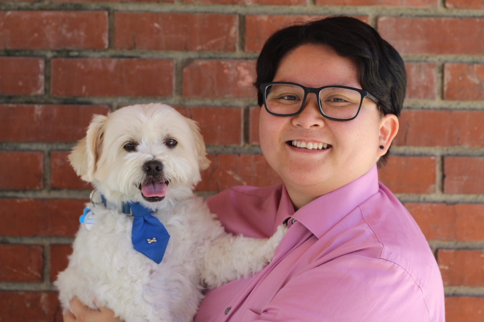 A person and their dog pose for a photo