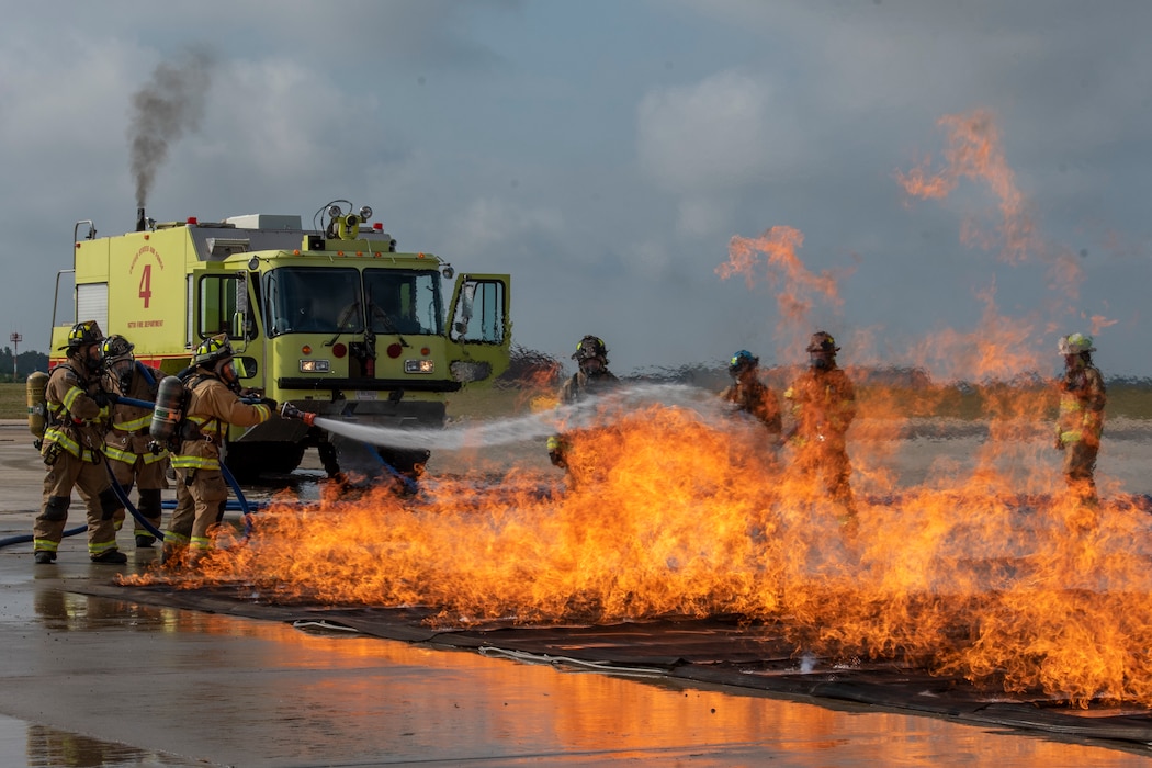 Firefighters from the 167th Airlift Wing fire department respond to a simulated aircraft crash to fulfill their annual Federal Aviation Administration Part 139 Live Fire Training