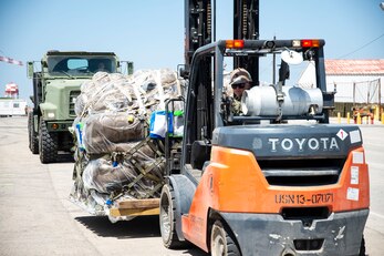 Equipment Operator 1st Class Britt Garrison, assigned to Naval Mobile Construction Battalion 133 (NMCB 133), offloads personnel gear on Camp Mitchell in Rota, Spain, August 24, 2023.