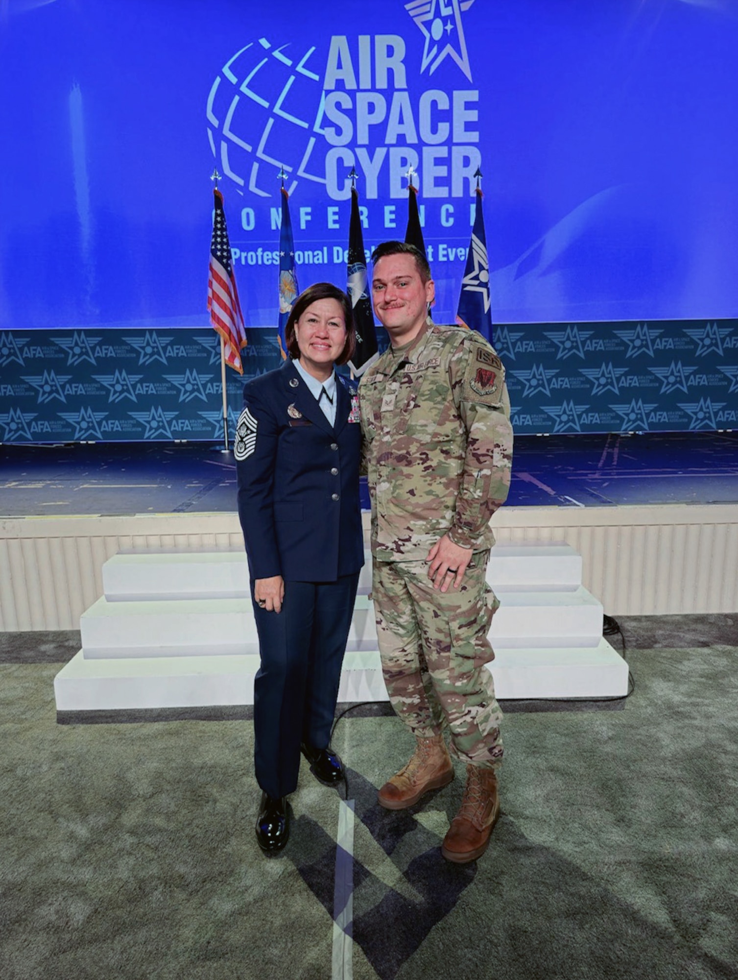 U.S. Air Force Justin Staton, 39th Electronic Warfare Squadron intelligence analyst, poses with Chief Master Sgt. of the Air Force JoAnne S. Bass, during the Air & Space Forces Association’s (AFA) Air, Space & Cyber Conference at the Gaylord National Resort & Convention Center in National Harbor, Md., Sept. 13, 2023. Events like AFA's Air, Space & Cyber Conference provide an in-person experience where members learn about the future of our force while also understanding the roadmap our leaders are taking to ensure we can win today’s fight and be ready to win tomorrow’s. (Courtesy Photo)