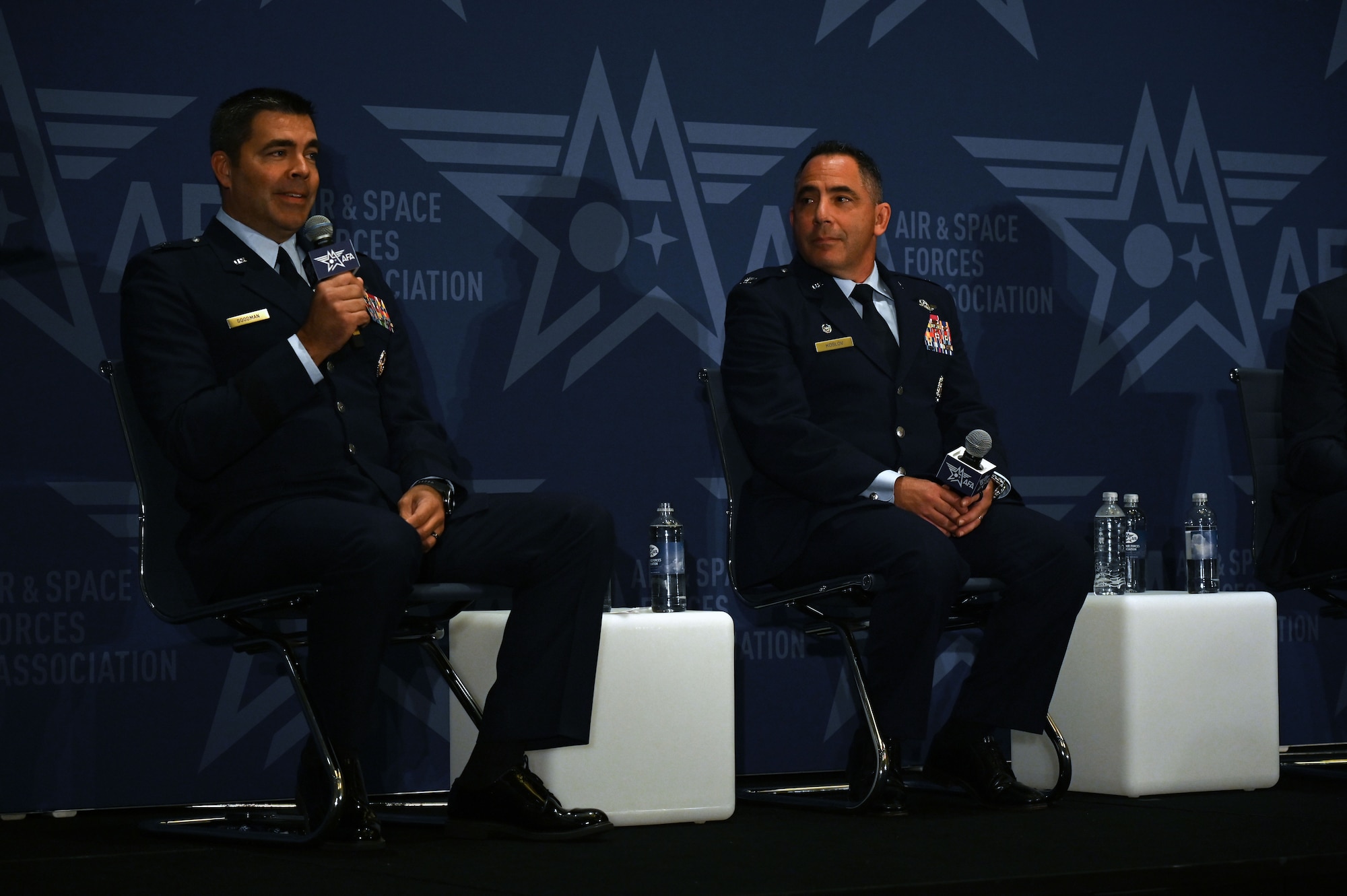 U.S. Air Force Brig. Gen. Richard Goodman, 57th Wing commander, left, U.S. Air Force Col. Josh Koslov, 350th Spectrum Warfare Wing commander, right, serve as panelist for the Spectrum Renaissance session  the Air & Space Forces Association’s (AFA) Air, Space & Cyber Conference at the Gaylord National Resort & Convention Center in National Harbor, Md., Sept. 13, 2023. During the panel, they discussed how the Spectrum has never been a more congested, contested and constrained domain to operate within. They spoke about the dependability between air assets and the EMS as inseparable and the survivability of Airmen depends on the Air Force achieving and maintaining EMS superiority. (U.S. Air Force photo by Staff Sgt. Ericka A. Woolever)