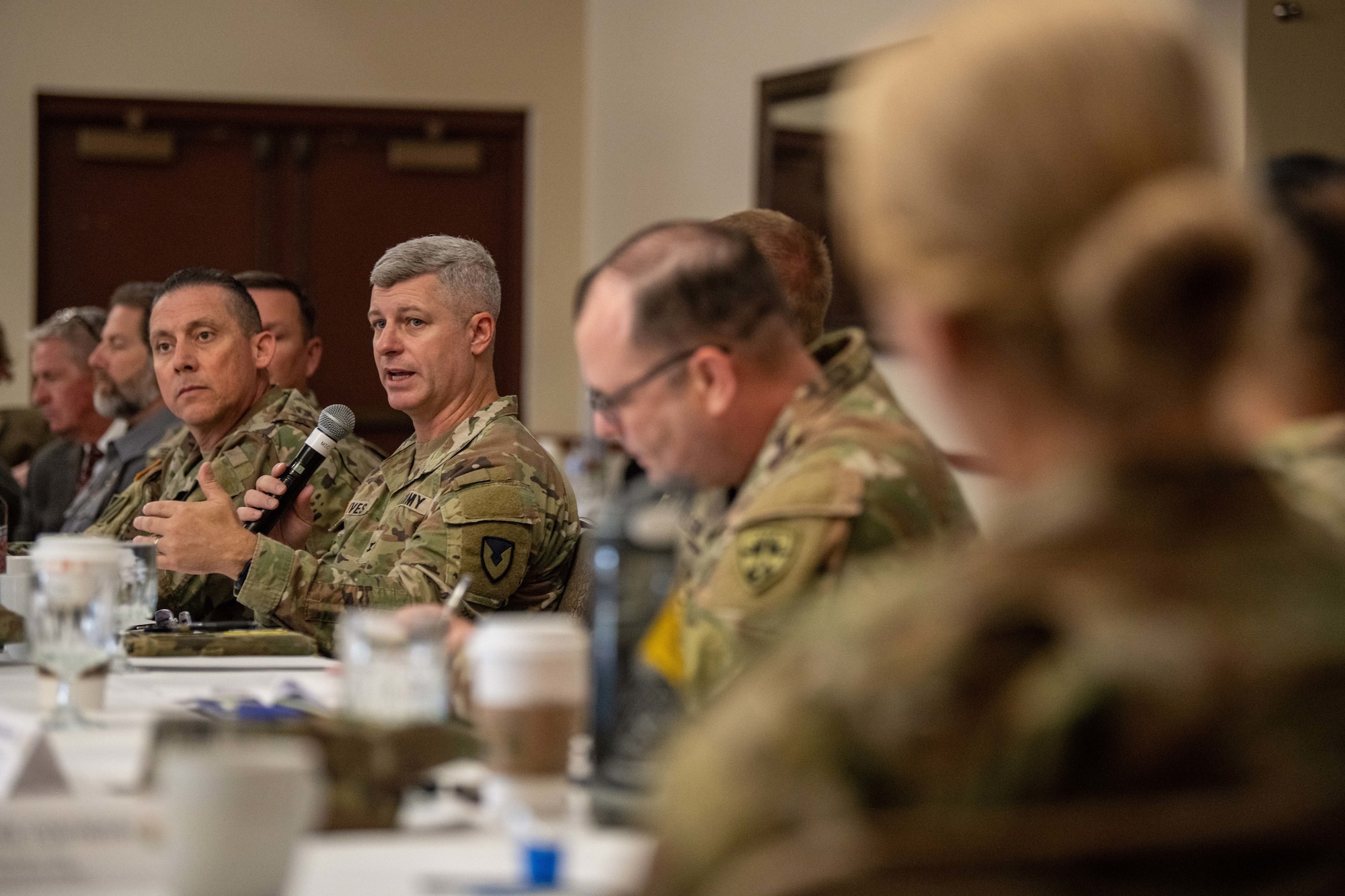 Group of military leaders listen to U.S. Army Col. John Ives as he speaks during the Arizona Commanders Summit.