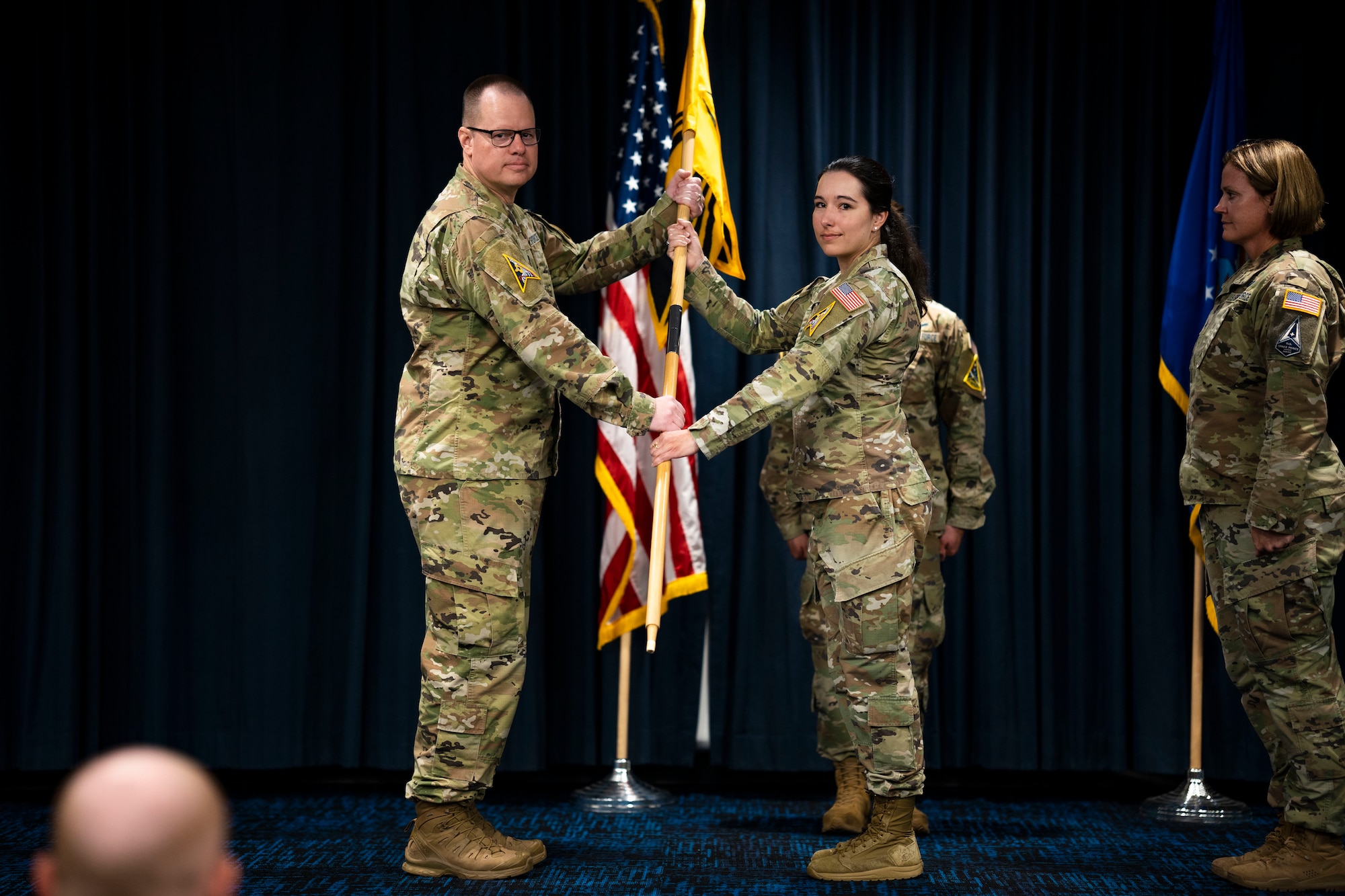 Man passes flag to woman.