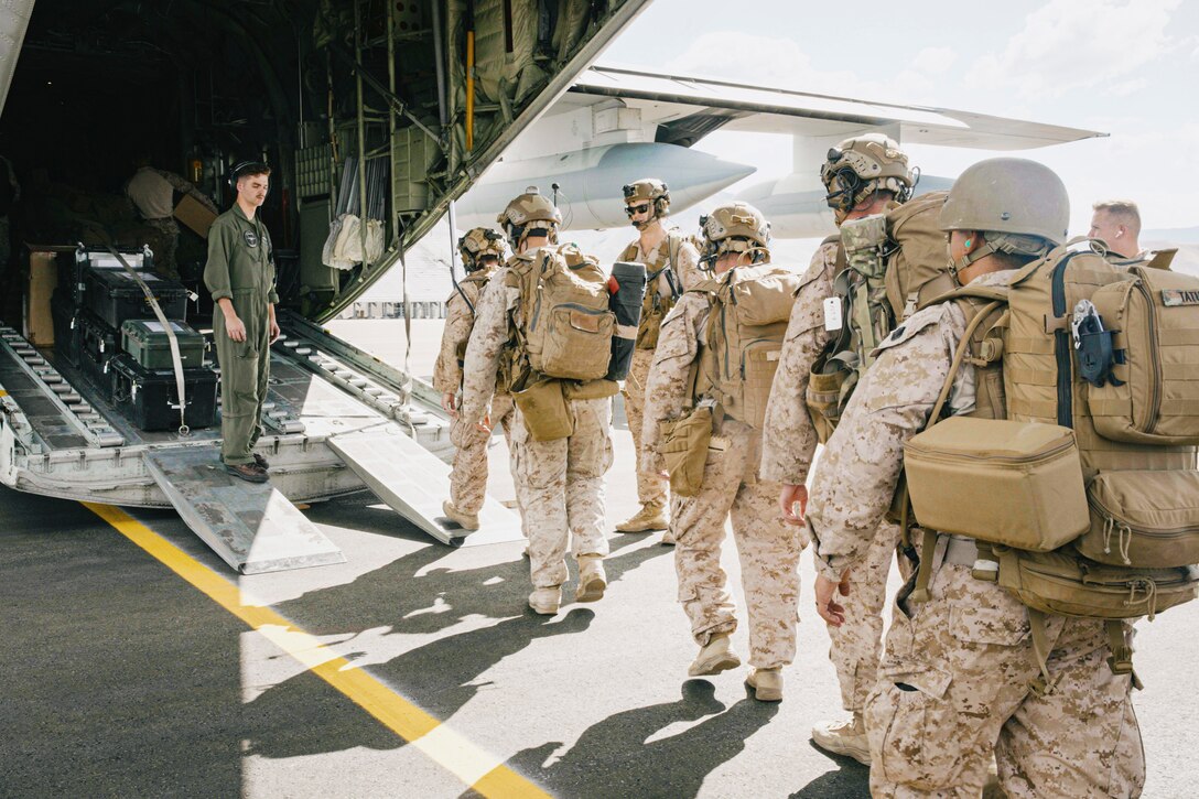 U.S. Marines assigned to the 15th Marine Expeditionary Unit board a KC-130J Super Hercules assigned to Marine Aerial Refueler Transport (VMGR) 352, Marine Aircraft Group 11, 3rd Marine Aircraft Wing, at Reno-Stead Airport, Nevada, marking the completion of a simulated military assisted departure during Realistic Urban Training exercise, Aug. 24, 2023. During the scenario, the 15th MEU conducted a mission coordinating with a U.S. Consulate until the situation necessitated an evacuation of consulate staff and American citizens from the area. RUT is a land-based predeployment exercise which enhances the integration and collective capability of the Marine Air-Ground Task Force while providing the 15th MEU an opportunity to train and execute operations in an urban environment. (U.S. Marine Corps photo by Cpl. Amelia Kang)