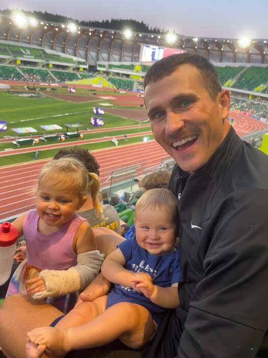 Airman 1st Class Daniel Michalski poses for a photo with his two children.