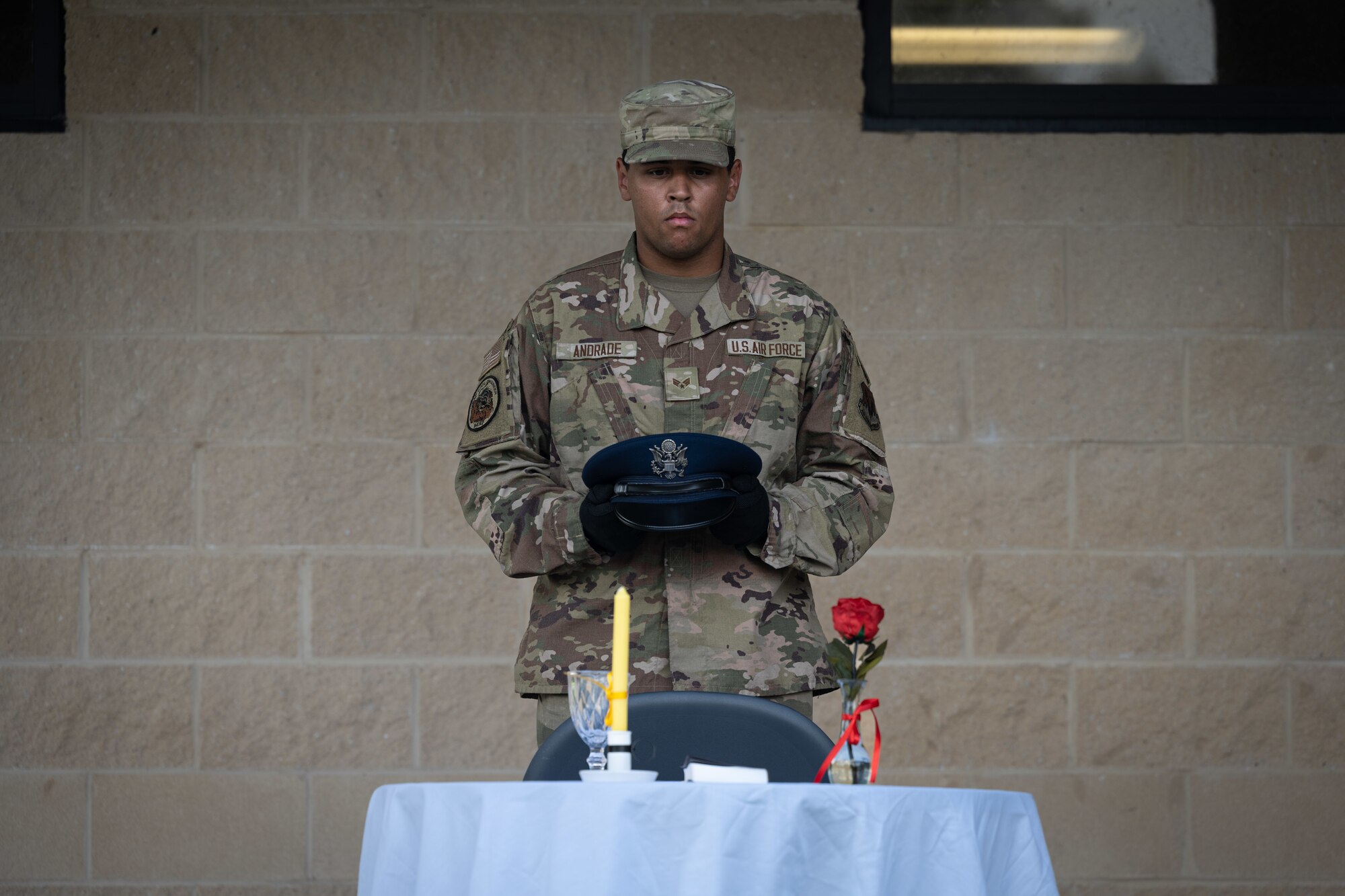 Senior Airman Daniel Andrade, a heating, ventilation, air conditioning and refrigeration technician, with the 4th Civil Engineer Squadron, displays a cover as part of a POW/MIA Remembrance day opening ceremony on Sept. 11, 2023 at Seymour Johnson Air Force Base, North Carolina.