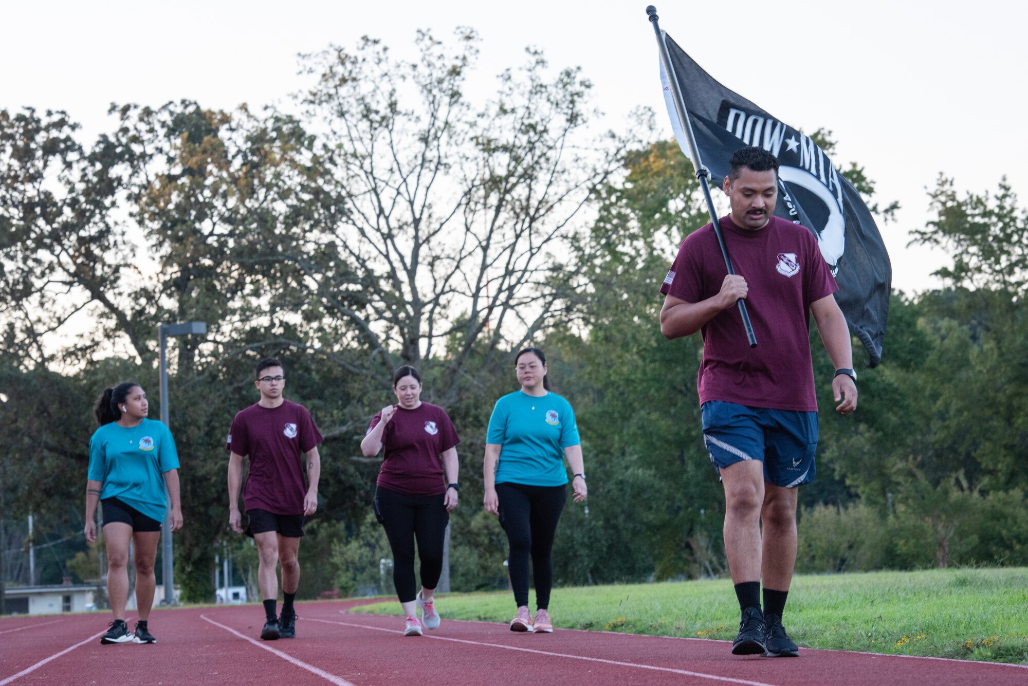 Airmen assigned to the 4th Health Care Operations Squadron carry the POW/MIA flag during a 24-hour vigil event as part of POW/MIA Recognition Day at Seymour Johnson Air Force Base, North Carolina, Sept. 15, 2023.