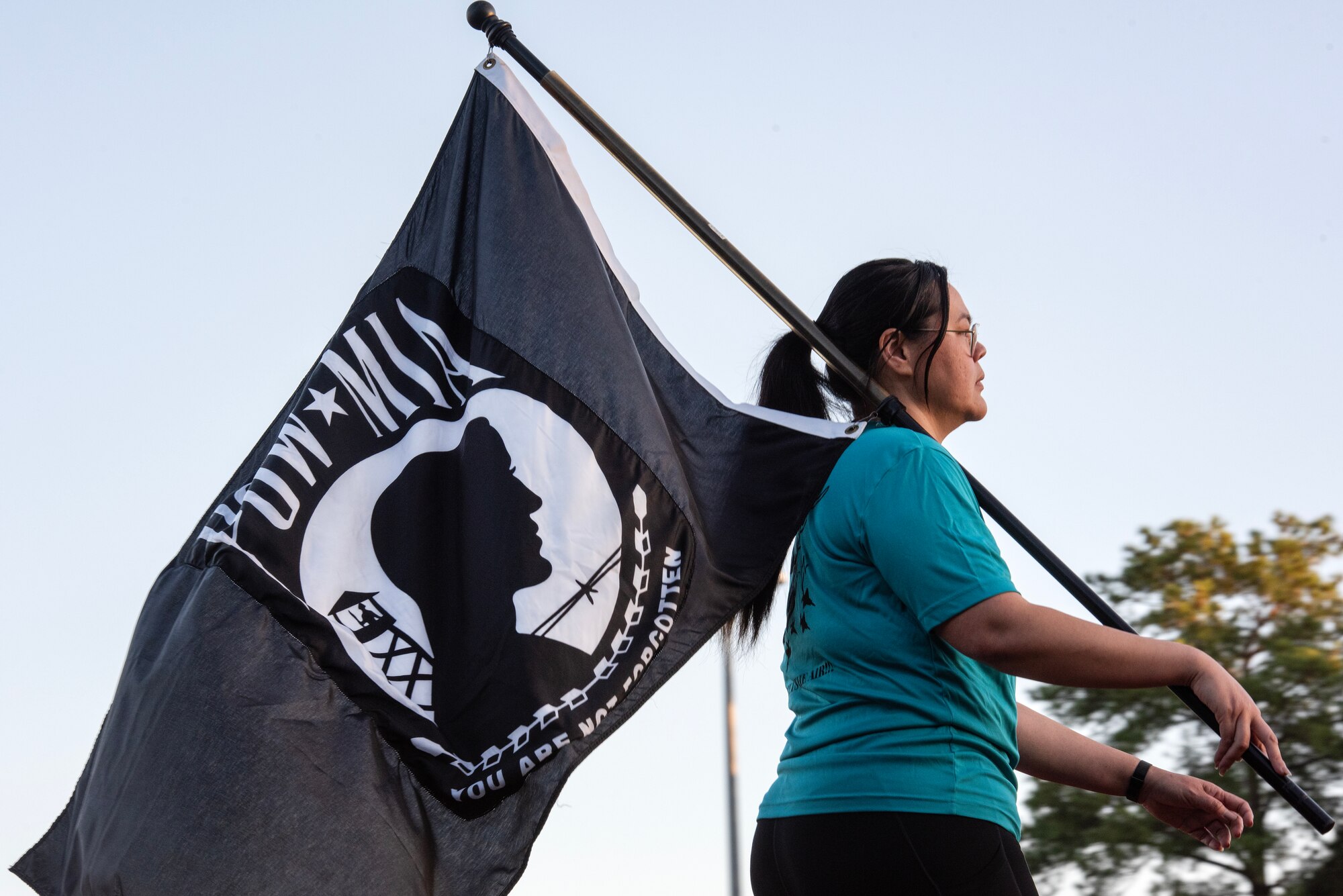 Staff Sgt. Consuelo Marahta, 4th Health Care Operations Squadron, carries the POW/MIA flag during a 24-hour vigil event as part of POW/MIA Recognition Day at Seymour Johnson Air Force Base, North Carolina, Sept. 15, 2023.