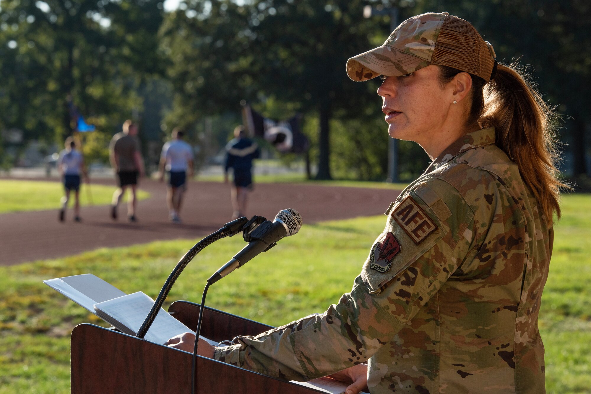 A1C Taylor Turner, 4th Operations Support Squadron, reads the names of prisoners of war and those missing in action as Airmen assigned to the 4th Civil Engineer Squadron carry the POW/MIA flag during a 24-hour vigil event as part of during a 24-hour vigil as part of POW/MIA Recognition Day at Seymour Johnson Air Force Base, North Carolina.