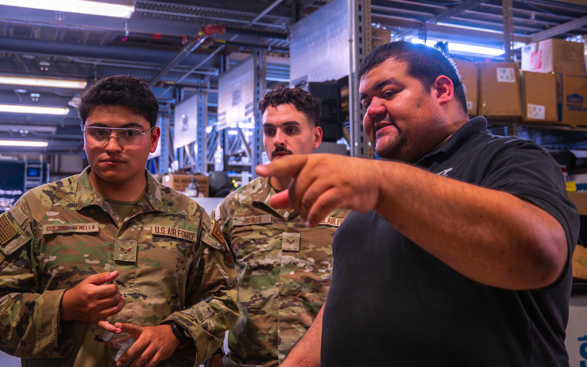 Dr. Jose Trevino (right), Radiological Assistance Program Region 4 outreach coordinator, speaks with U.S. Air Force Senior Airman Nestor Guevara-Rapenella (left), and Senior Airman Nicholas Howes (center), 56th Civil Engineer Squadron explosive ordnance disposal technicians, during training exercise Road RAPTER or Radiological Assistance Program Training for Emergency Response Sept. 5, 2023, at Luke Air Force Base, Arizona.