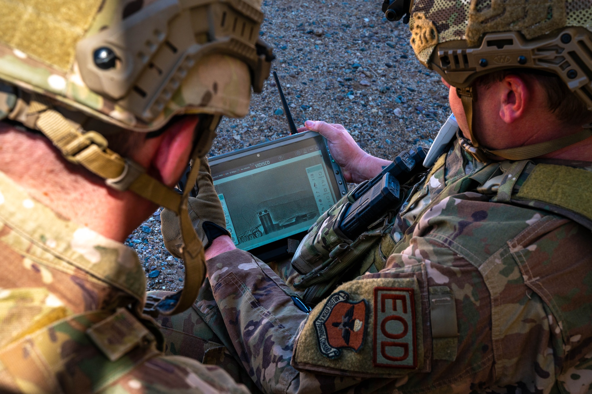 U.S. Air Force Staff Sgt. Zackary Stringer (left), and Senior Airman Steven Webb (right), 56th Civil Engineer Squadron explosive ordnance disposal technicians, examine an x-ray during training exercise Road RAPTER or Radiological Assistance Program Training for Emergency Response Sept. 7, 2023, at Luke Air Force Base, Arizona.