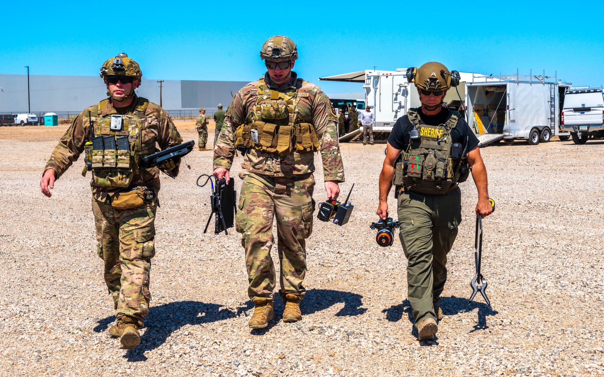 U.S. Air Force Senior Airman Steven Webb (left), Staff Sgt. Zackary Stringer (center), 56th Civil Engineer Squadron explosive ordnance disposal technicians, and Deputy Jason Schweizer (right), Maricopa County Sheriff‘s Office bomb technician, carry x-ray equipment during training exercise Road RAPTER  or Radiological Assistance Program Training for Emergency Response Sept. 7, 2023, at Luke Air Force Base, Arizona.
