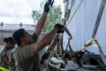 U.S. Air Force Airmen with the 437th Aerial Port Squadron show U.S.Soldiers with the 3rd Expeditionary Sustainment Command how to prepare equipment for flight.