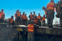 U.S. Soldiers with the 3rd Expeditionary Sustainment Command learn how to tie down equipment on a supply train.