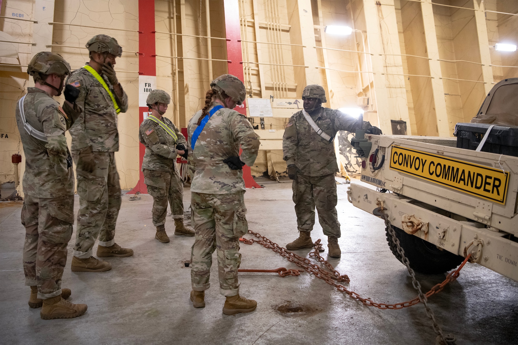 U.S. Soldiers with the 3rd Expeditionary Sustainment Command learn how to properly secure equipment on a supply ship.