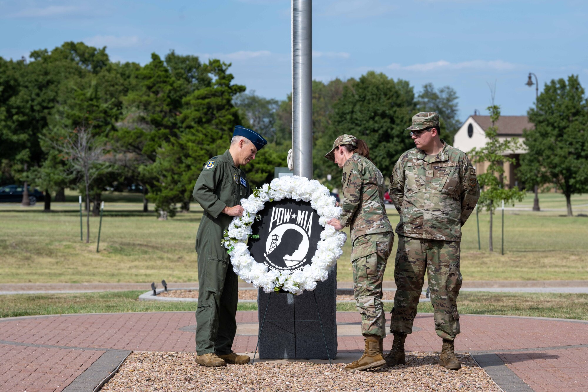 Col. Jacob Thornburg, 22nd Air Refueling Wing deputy commander, and Chief Master Sgt. Laura Hoover, 22nd ARW command chief, lay a wreath outside the wing headquarters building Sept. 13, 2023, at McConnell Air Force Base, Kansas. The Wreath-Laying Ceremony honors the legacy of fallen heroes who were prisoners of war or missing in action. (U.S. Air Force photo by Airman 1st Class William Lunn)