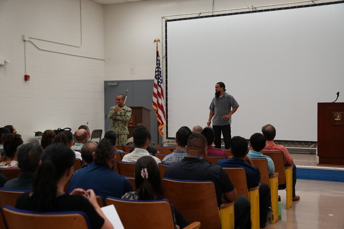 CAPT Stephen Padhi and Daris Cook address the command during and All Hands meeting.