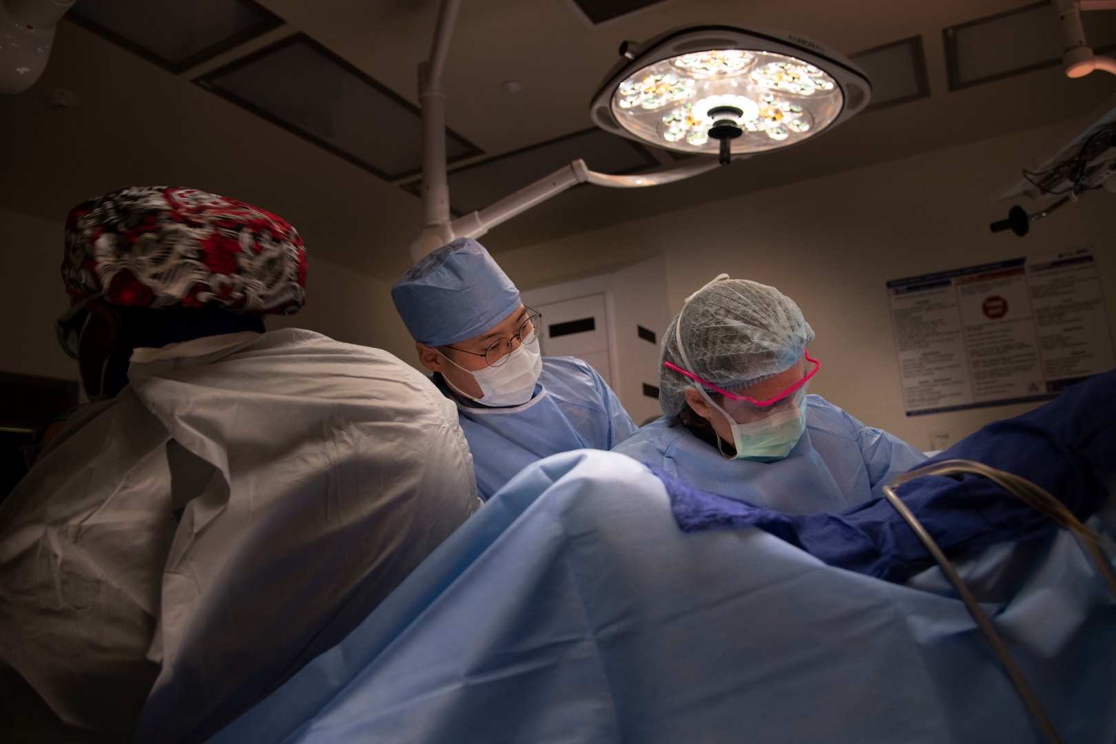 military doctors and surgical technician in operating room