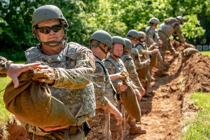 Airmen from the Kentucky Air National Guard’s 123rd Civil Engineer Squadron construct defensive fighting positions during a training exercise in Shepherdsville, Ky., June 2, 2023. The purpose of the training was to promote multi-capable Airmen by training them on skills outside of their primary jobs. (U.S. Air National Guard photo by Tech. Sgt. Joshua Horton)