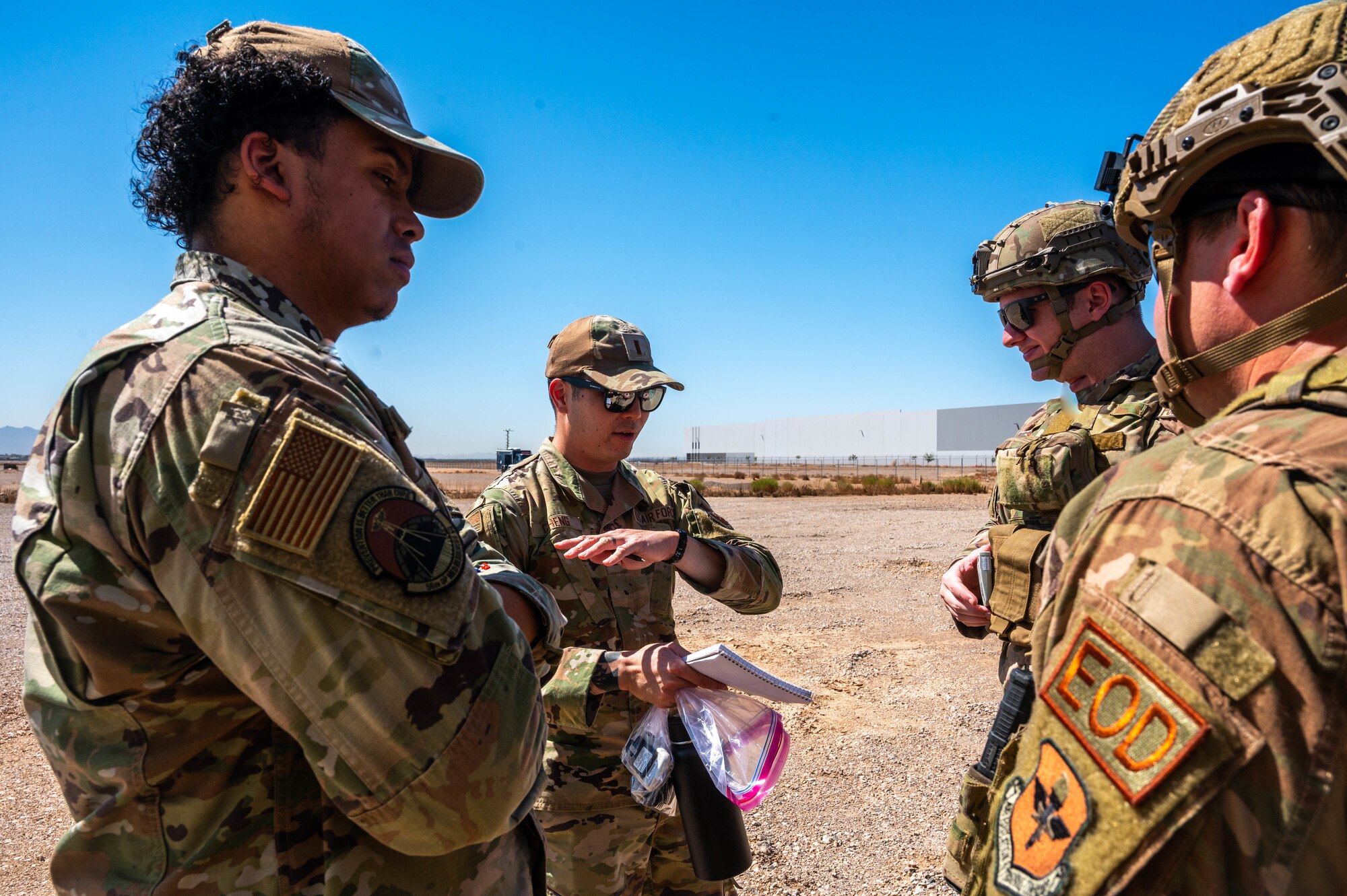 U.S. Air Force 2nd Lt. Robert Cheng, 56th Operations Medical Readiness Squadron bioenvironmental engineer, speaks to members of the 56th Civil Engineer Squadron explosive ordnance disposal team during training exercise Road RAPTER or Radiological Assistance Program Training for Emergency Response Sept. 7, 2023, at Luke Air Force Base, Arizona.