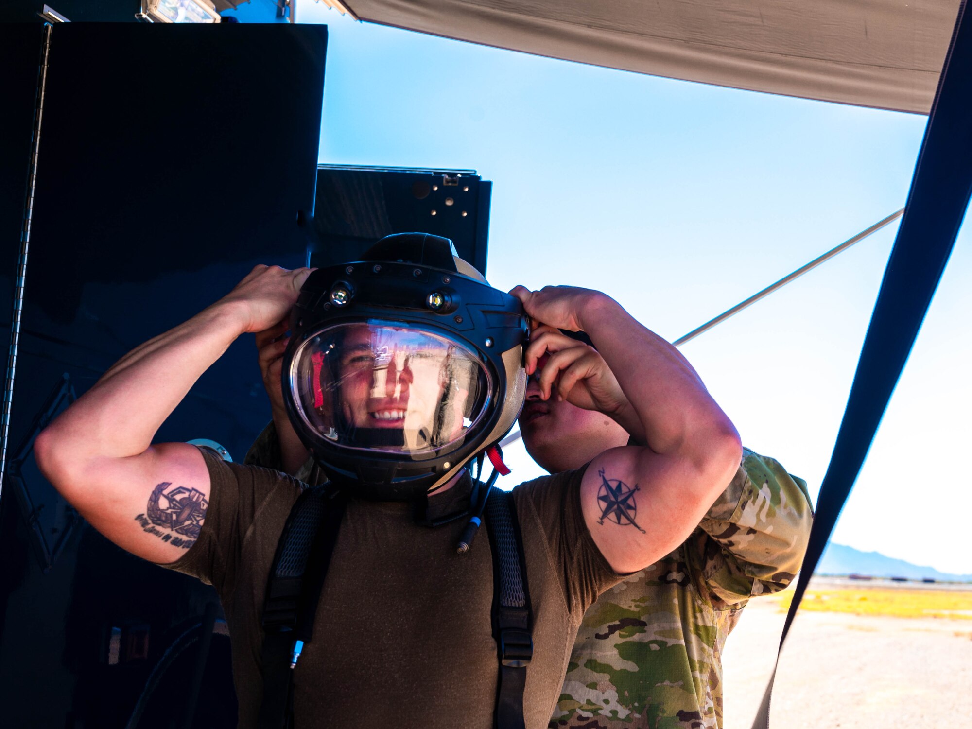U.S. Air Force TSgt Kristin Ponce, 56th Civil Engineer Squadron explosive ordnance disposal technician, removes the helmet of his bomb suit during training exercise Road RAPTER or Radiological Assistance Program Training for Emergency Response Sept. 7, 2023, at Luke Air Force Base, Arizona.