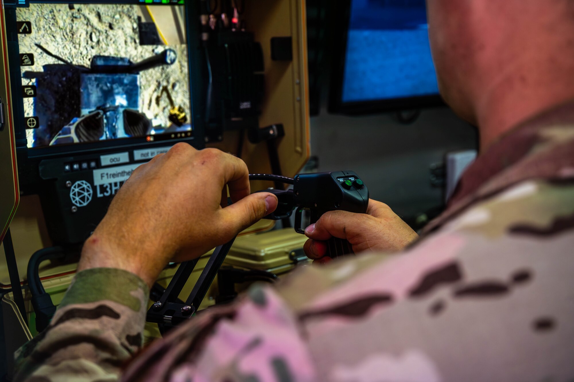 U.S. Air Force Senior Airman Austin Huff, 56th Civil Engineer Squadron explosive ordnance disposal technician, remotely operates a robot during training exercise Road RAPTER or Radiological Assistance Program Training for Emergency Response Sept. 7, 2023, at Luke Air Force Base, Arizona.