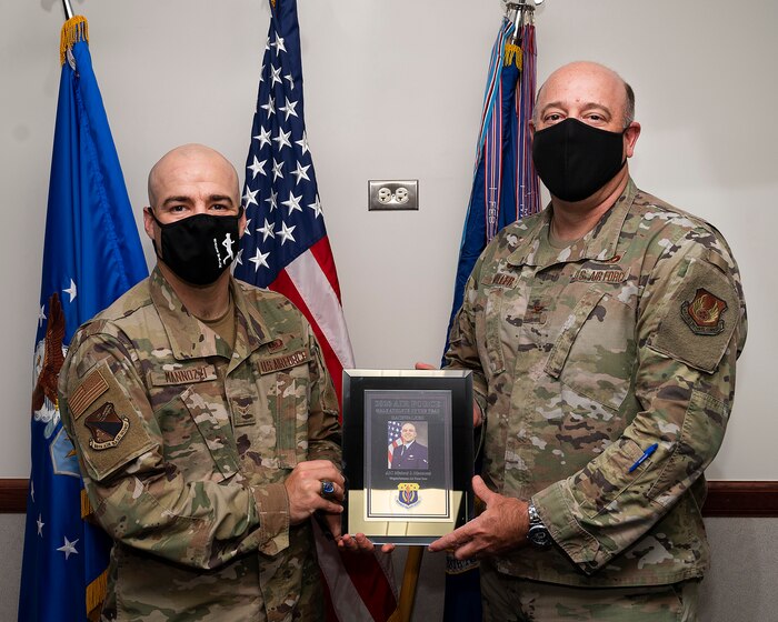 Col. Patrick Miller presents the 2020 Air Force Athlete of the Year award to Airman 1st Class Michael Mannozzi