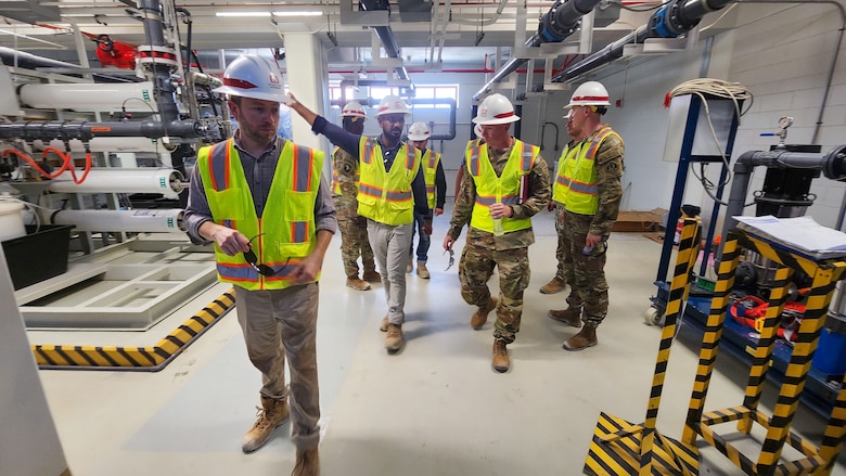 U.S. Army Corps of Engineers Transatlantic Middle East District Bahrain Area Office personnel point out engineering updates to U.S. Army Col. William C. Hannan, Jr., Army Corps of Engineers Transatlantic Division commander, during a site visit to view ongoing base infrastructure projects supporting U.S. Naval Forces Central Command and Naval Support Activity Bahrain, Sept. 11, 2023.