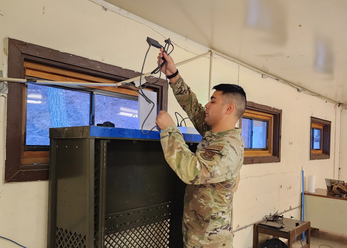 Male Airman installs the WiFi to set up the communications for the advance team and command section.