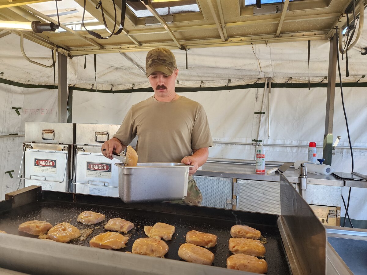 Male Airman prepares dinner for the Reserve members.