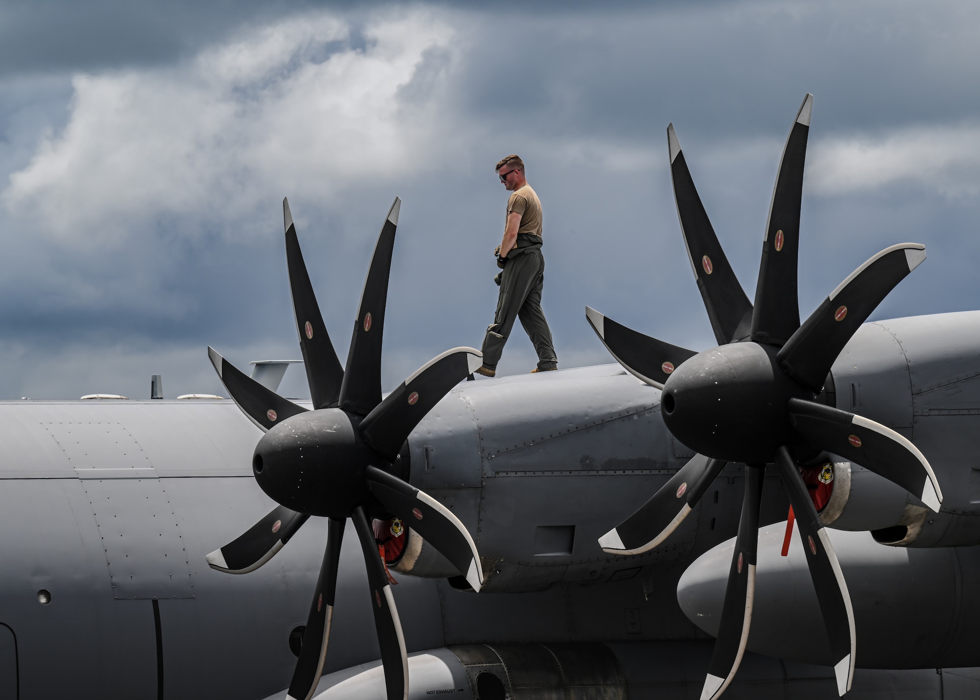U.S. Air Force flight engineer and maintainer perform routine maintenance checks on a C-130H Hercules aircraft.