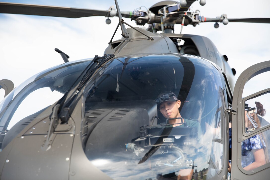 A child sits in the front of a UH-72 Lakota at the 2023 Frankfort Aviation day in Frankfort, Kentucky, Sept. 16, 2023. Visitors to the event had the opportunity to explore Kentucky Army National Guard Aviation assets in static displays. (U.S. Army National Guard photo by Spc. Caleb Sooter)