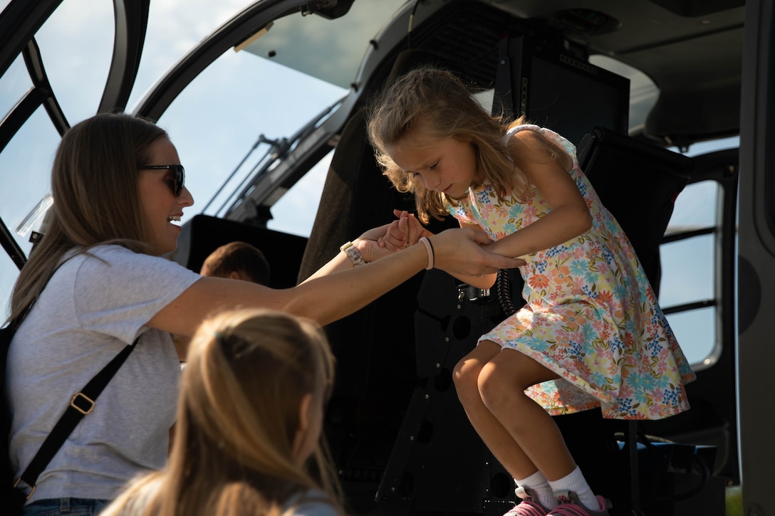 A child exits a UH-72 Lakota at the 2023 Frankfort Aviation day in Frankfort, Kentucky, Sept. 16, 2023. Visitors to the event had the opportunity to explore Kentucky Army National Guard Aviation assets in static displays. (U.S. Army National Guard photo by Spc. Caleb Sooter)