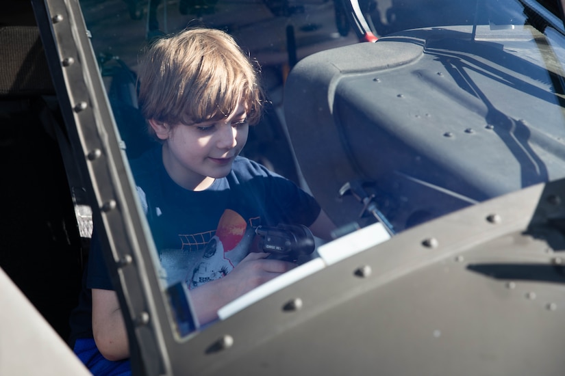 A child sits in a UH-60 Black Hawk at the 2023 Frankfort Aviation Day in Frankfort, Kentucky, Sept. 16, 2023. The Black Hawk is one of the primary aircraft used by the 63rd Theater Aviation Brigade in tactical and humanitarian operations. (U.S. Army National Guard photo by Spc. Caleb Sooter)