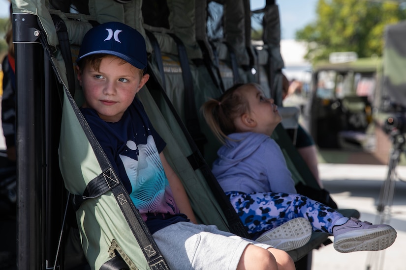 Children sit in the back of a UH-60 Black Hawk at the 2023 Frankfort Aviation Day in Frankfort, Kentucky, Sept. 16, 2023. The Black Hawk is one of the primary aircraft used by the 63rd Theater Aviation Brigade in tactical and humanitarian operations. (U.S. Army National Guard photo by Spc. Caleb Sooter)