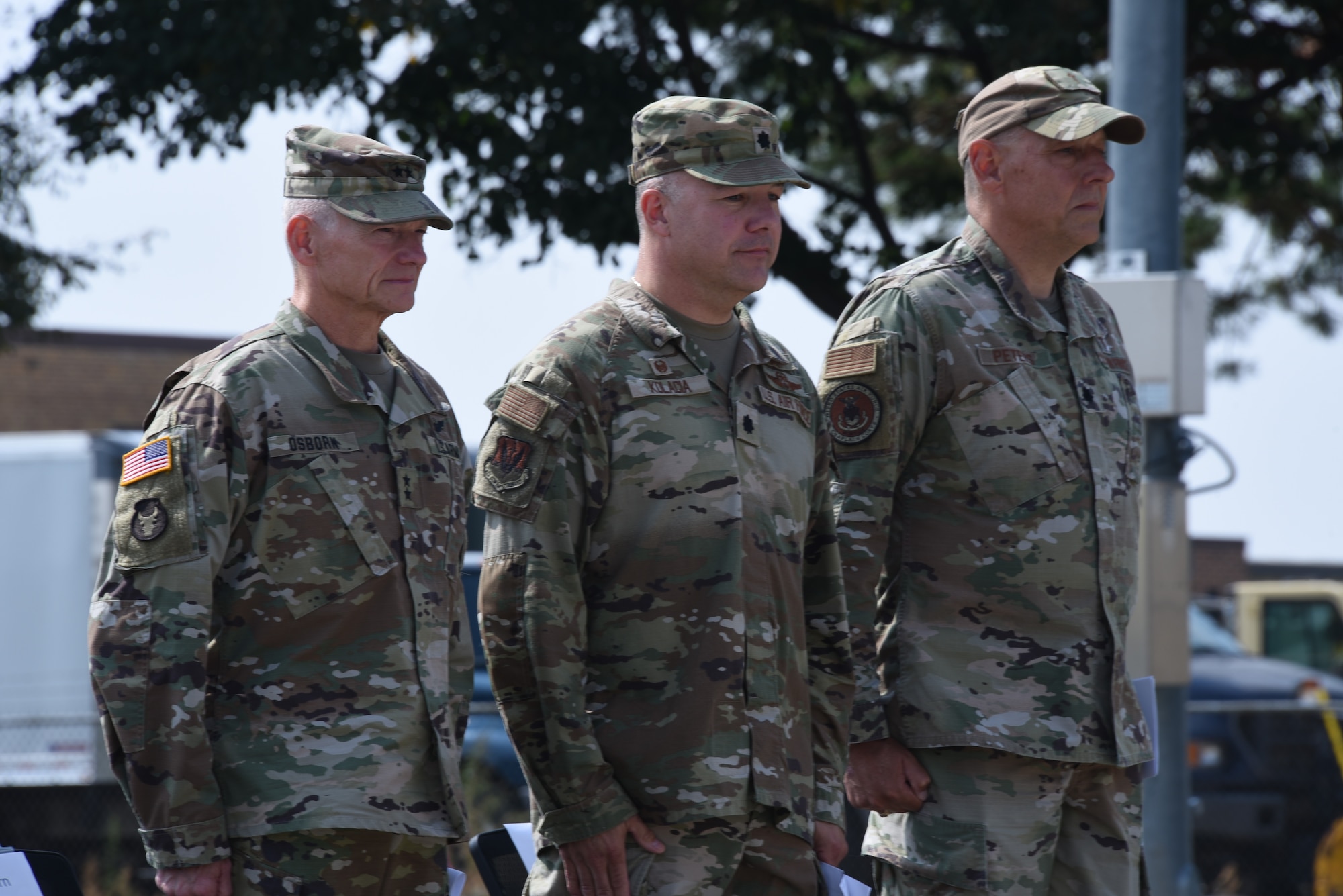 U.S. Army National Guard Maj. Gen. Stephen Osborn, Adjutant General for the Iowa National Guard, left, U.S. Air National Guard Lt. Col. Jason Kolacia, 133rd Test Squadron commander, center, and Lt. Col. Steve Peters, a 185th Air Refueling Wing chaplain, right, stand during the 133rd Test Squadron 75th Anniversary celebration ceremony
